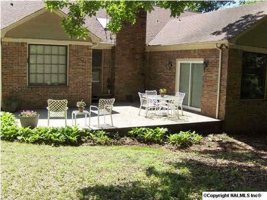 Back patio with peaceful view of trees in back yard