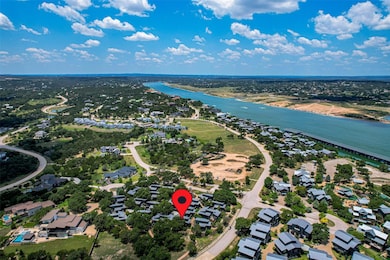 Aerial view of property's location with a large body of water and nearby suburban area