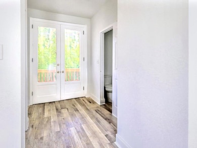 Doorway featuring french doors and light hardwood 