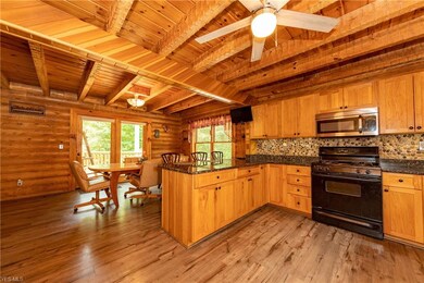 Another view of the kitchen with a view of the breakfast bar and dining room!