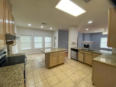 Kitchen with stainless steel appliances, a center