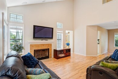Living room has vaulted ceiling, tile surround fir