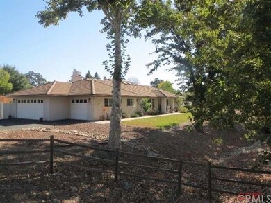 another view with 3 car garage and beautiful woode