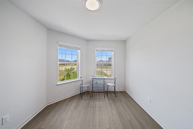 Bright dining space with double windows brings in natural light and a welcoming atmosphere.