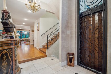 The main entry has a staircase and glass elevator