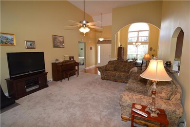 Reverse look of living room showing the foyer and formal dining
