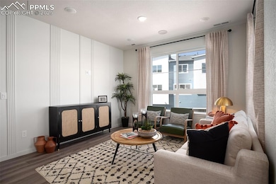Living room featuring wood finished floors, baseboards, and recessed lighting
