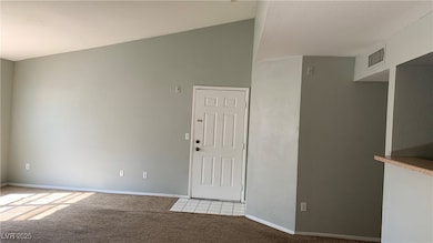 Spare room with light carpet, baseboards, and loft