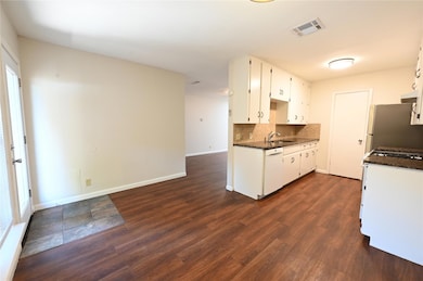 Kitchen featuring dishwasher, freestanding refrig