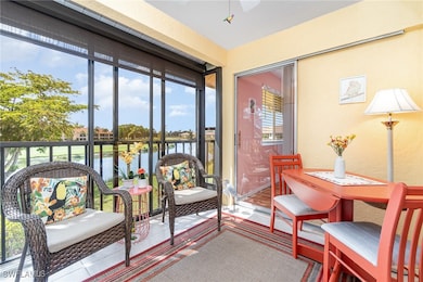 Sunroom featuring a water view and ceiling fan