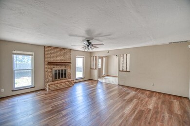 Unfurnished living room featuring wood-type floori