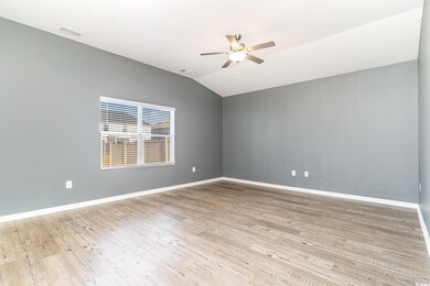 Unfurnished room featuring visible vents, baseboards, and wood finished floors