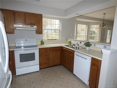 Efficient kitchen has white appliances for a class