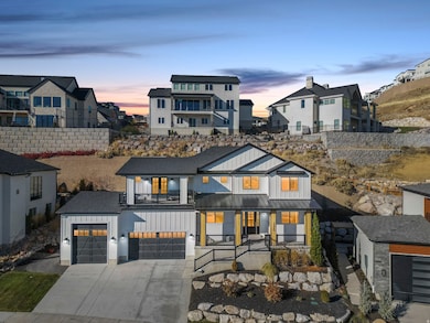 Modern farmhouse style home featuring board and batten siding, driveway, a porch, and a standing seam roof