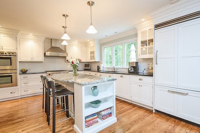 Updated kitchen with center island-top of line appliances