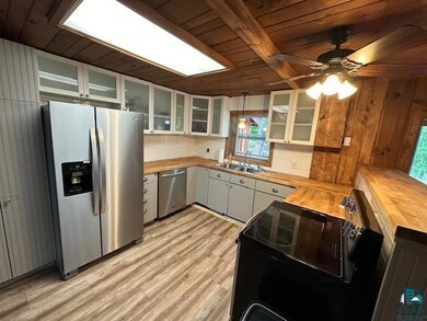 Kitchen featuring butcher block countertops, appli