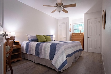 Bedroom featuring wood finished floors, a closet,