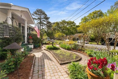 The front walk is surrounded by lovingly maintained gardens, offering beauty all year long.