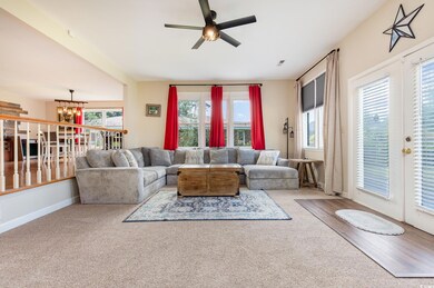 Living room featuring ceiling fan with notable cha