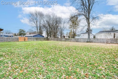 Fenced backyard featuring a residential view