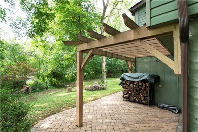 walkway leads to back paved patio area, and contin