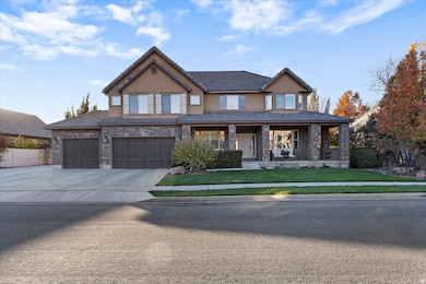 View of front of home featuring covered porch, concrete driveway, stucco siding, a garage, and brick siding