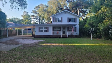 View of front facade featuring a carport, a porch,