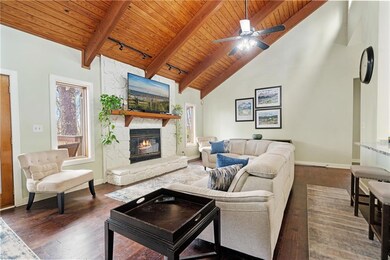 Living room featuring dark wood-style flooring, hi