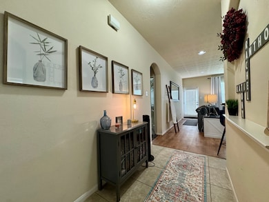Hallway to living room, kitchen, primary bedroom a
