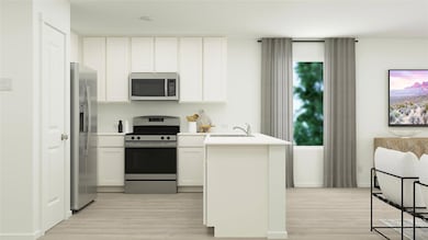 Kitchen with white cabinetry, sink, light wood-typ