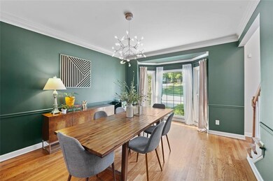 Dining space with a chandelier, light wood-style f