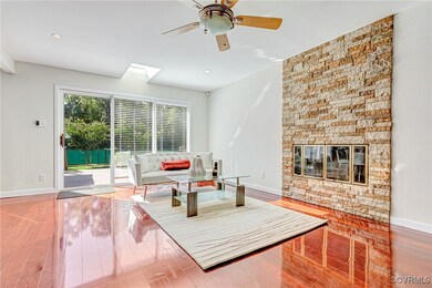 Living room featuring a skylight, a fireplace, and