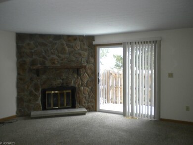 Living room with stone fireplace! Sliding door to 