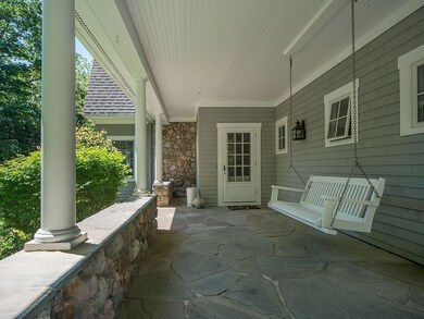 Charming front porch with swing. ...