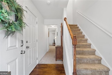 This entry level maximizes flow with access to the garage, a private ensuite bedroom, and a staircase that leads to the main living space above.