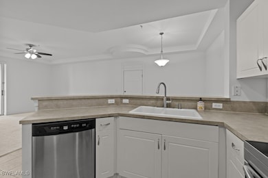 Kitchen featuring white cabinets, dishwasher, ligh