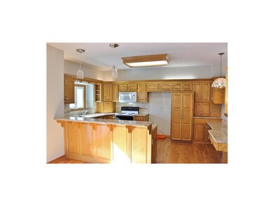 The kitchen has stained cabinets, full pantry (wit