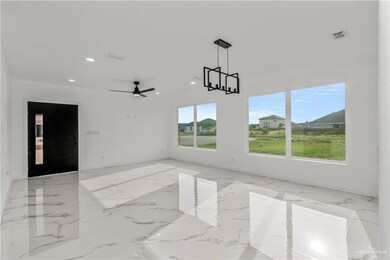 Tiled spare room featuring ceiling fan