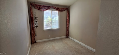 Empty room featuring light carpet and a textured wall