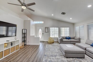 Living room featuring lofted ceiling, wood finishe