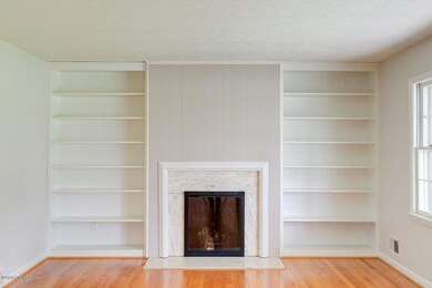 LIVING ROOM w/FIREPLACE AND BOOKSHELVES