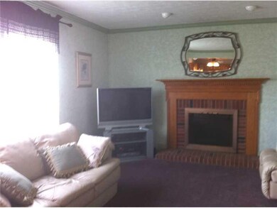 Family Room. The gas fireplace with its lovely brick and trim surround is the focal point of the generously sized family room