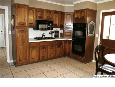 The kitchen features three walls of cabinet space 