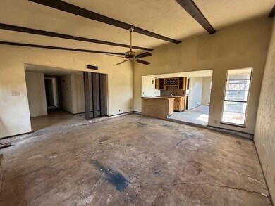 Unfurnished living room with ceiling fan and beame