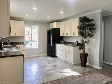 Bright kitchen with new appliances and recessed lighting