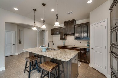 Kitchen has lots of cabinets, big island that can 