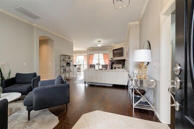 Living room featuring ceiling fan, ornamental mold