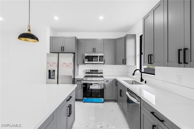 Kitchen featuring stainless steel appliances, gray