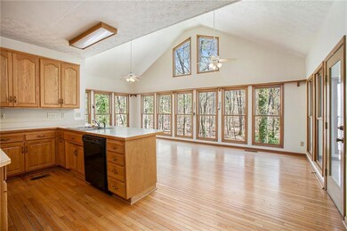 Kitchen with dishwasher, ceiling fan, light hardwo