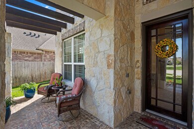 Beautiful stone exterior and a pergola covered front porch